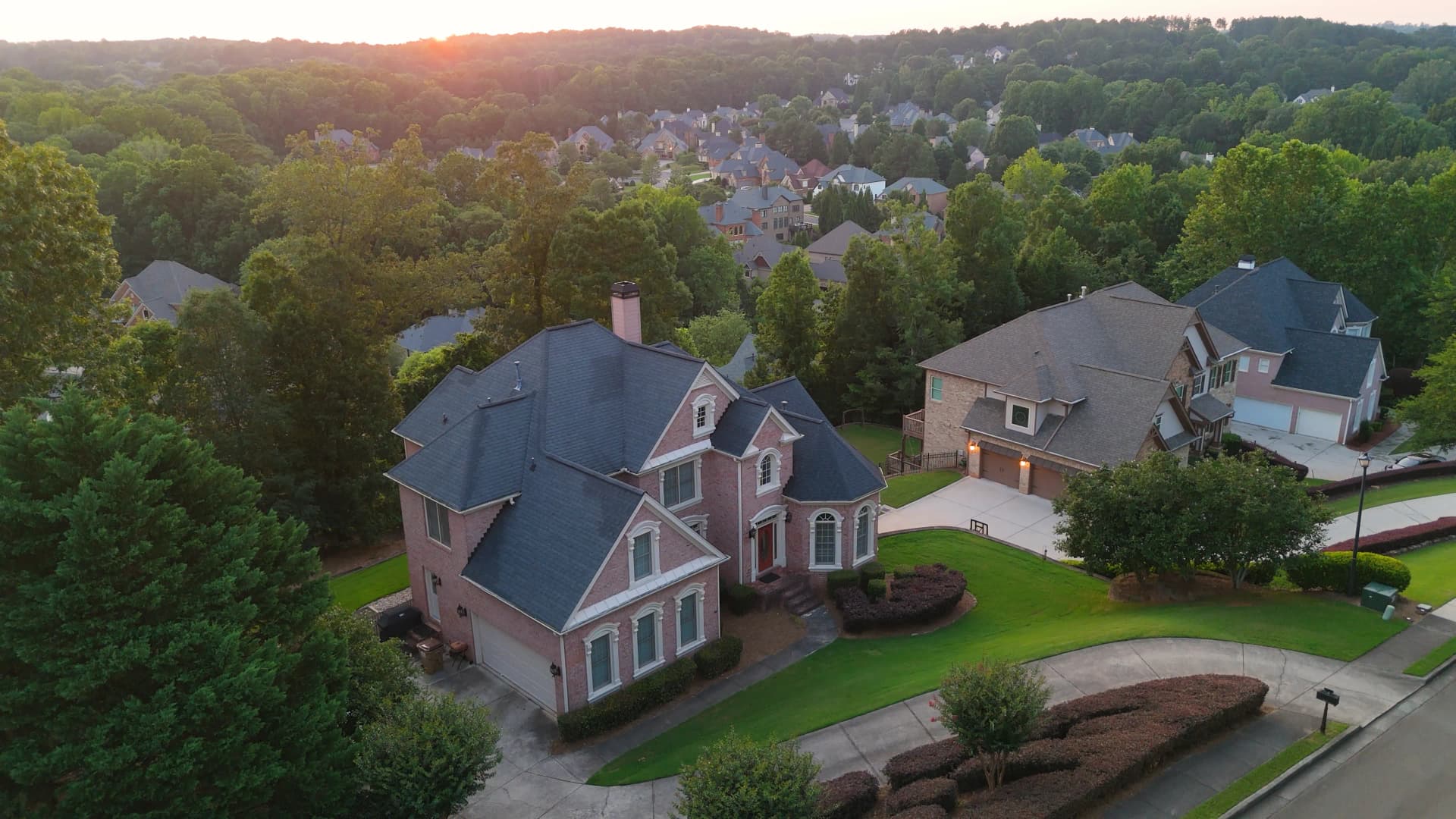 Aerial view of an Atlanta neighborhood at golden hour, rooftops in view