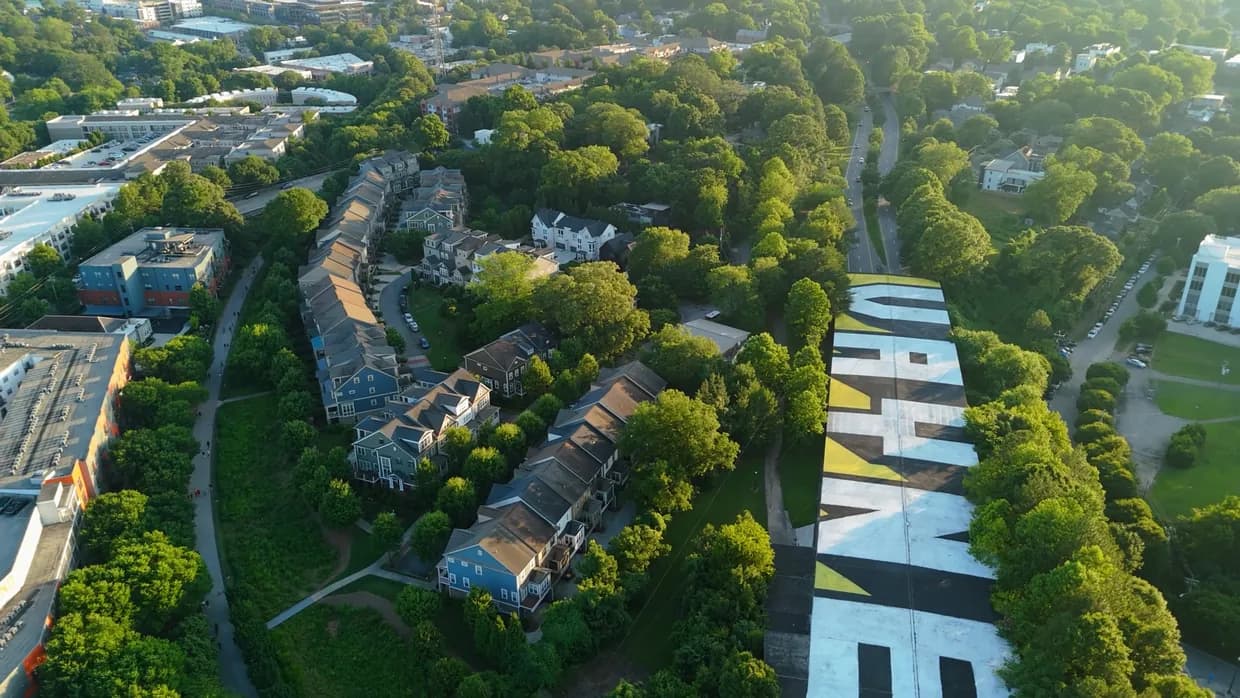 Aerial view of the Atlanta Beltline Eastside Trail, with the path running between homes, businesses, and a painted mural